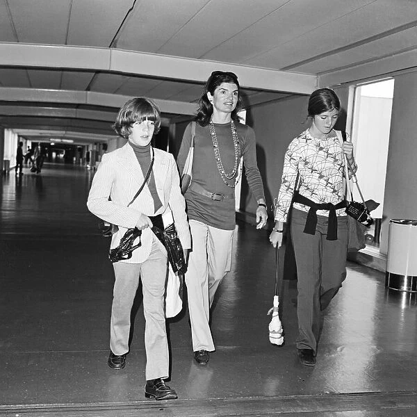 Jackie Onassis pictured at Heathrow Airport in London, pictured with her two children