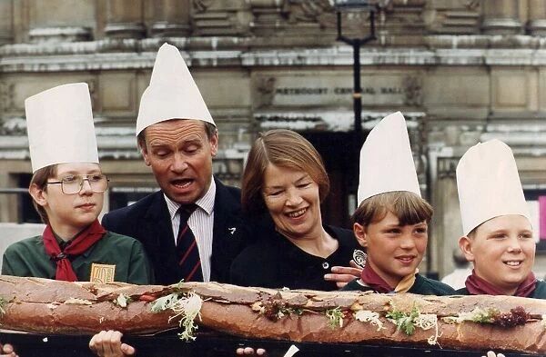 Jeffrey Archer and Glenda Jackson with some cub scouts wearing chef