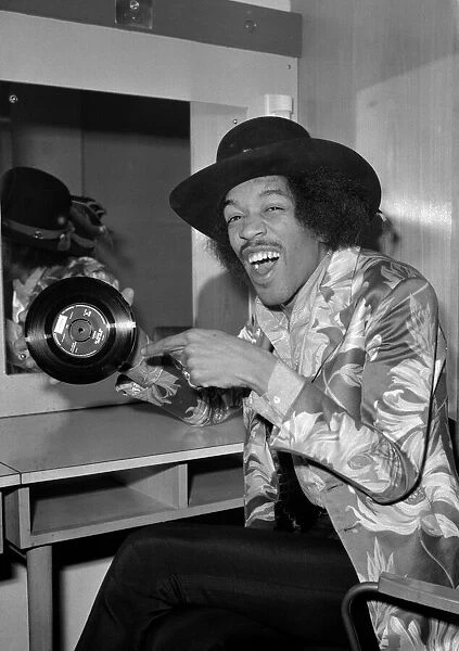 Jimi Hendrix pointing to a copy of his new 7'release with Curtis Knight - Hush Now