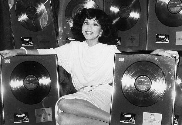 Joan Collins with gold discs presented for The Bitch soundtrack - March 1980