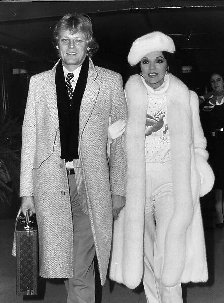 Joan Collins at Heathrow Airport with boyfriend Peter Holm. December 1984