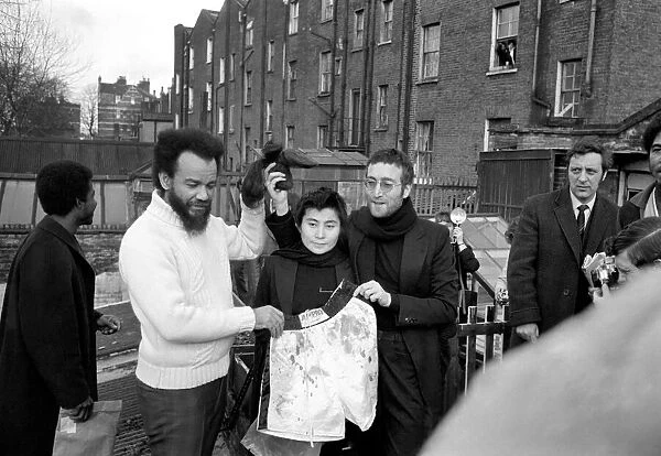 John Lennon and Yoko pictured on the roof of Black House in Holloway Road, with Michael X