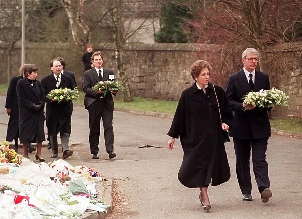 John Major Prime Minister and his wife Norma walking with wreath at Dunblane Primary