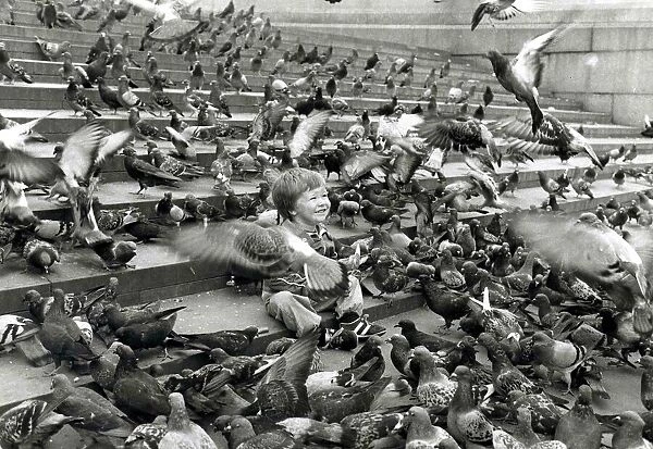 John Milller surrounded by pigeons in Trafalger Square. September 30th 1983
