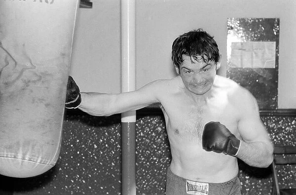 Johnny Frankham Boxer May 1975 hitting punchbag in his training gym traing for his next