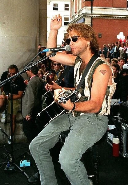 Jon Bon Jovi pop star busking in Covent Garden to the crowds Playing