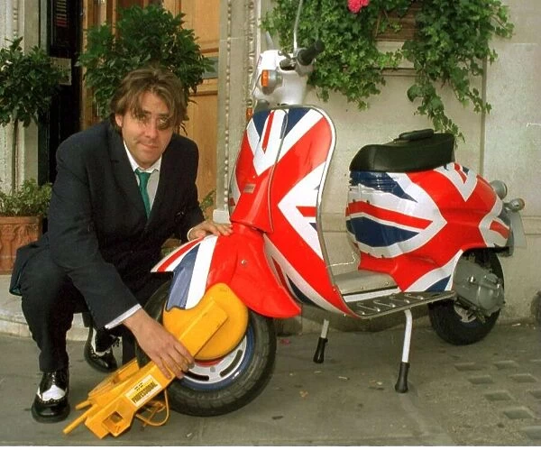 Jonathan Ross TV Presenter has his scooter clamped outside virgin radio this morning by