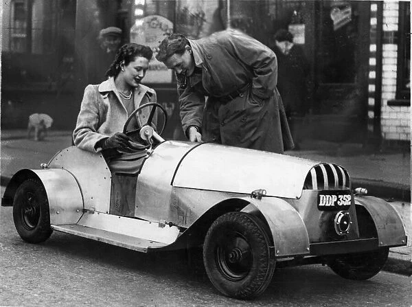Kenneth See of Oxford Road, Reading, shows his wide Georgina the controls of his electric