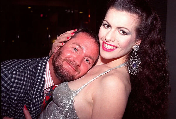 Kenny Everett rests on cleavage of Cleo Rocos 1988