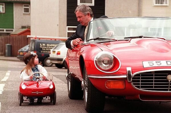 Kerri Duncan in Toy E type Jaguar car April 1998, parked alongside Graeme Moyes principal