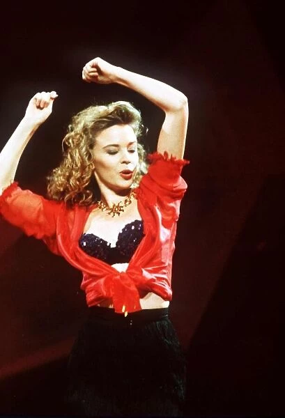 Kylie Minogue actress & singer on stage with arms in air