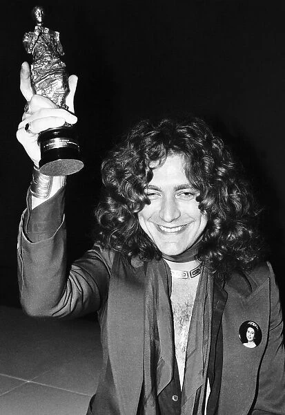 Lead singer of group Led Zeppelin Robert Plant with an Ivor Novello Award