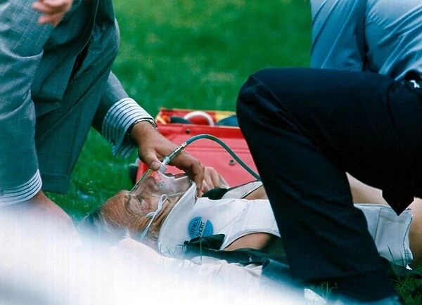 Lester Piggott receives treatment after falling from Coffe n Cream at Goodwood racecourse