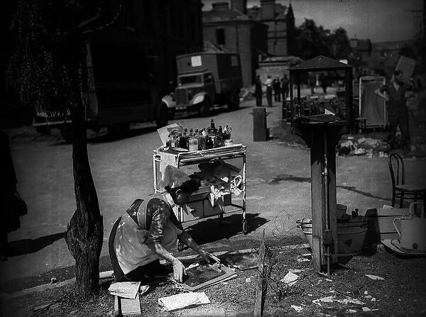 Lewisham Hospital after air Raid during WW2 1944 with nurse collecting some