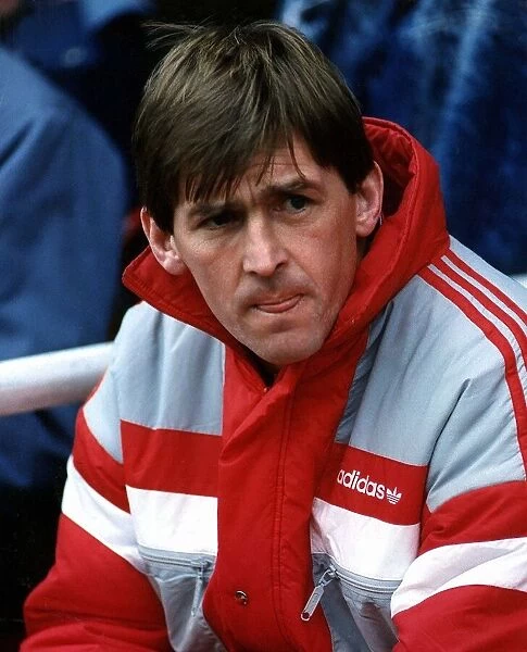 Liverpool manager Kenny Dalglish wearing an adidas coat as he watches his team from