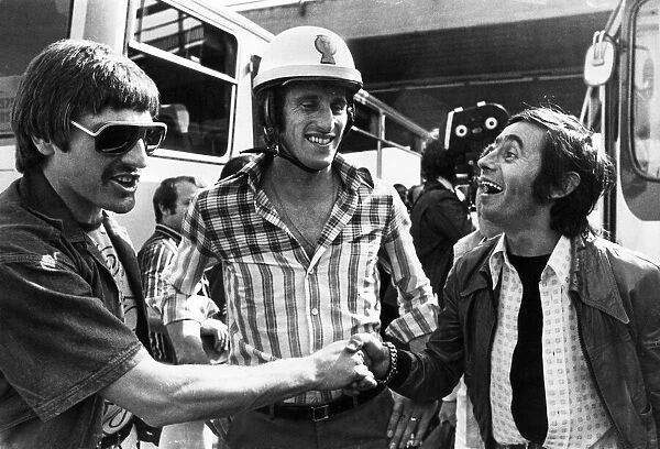 Liverpool players Steve Heighway and Ray Clemence share a joke with a fan outside