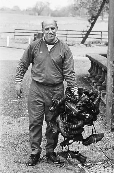Liverpool trainer Ronnie Moran holding a large collection of player