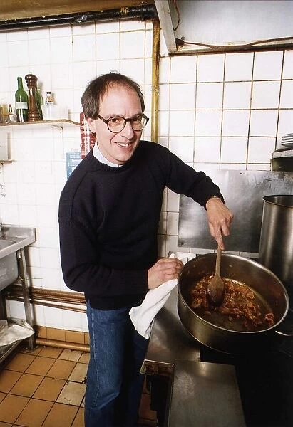 Lloyd Grossman TV Presenter of Master Chef in his own kitchen trying out his own cooking