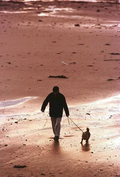 Man walking Dog on Beach in Aberdeen October 1999