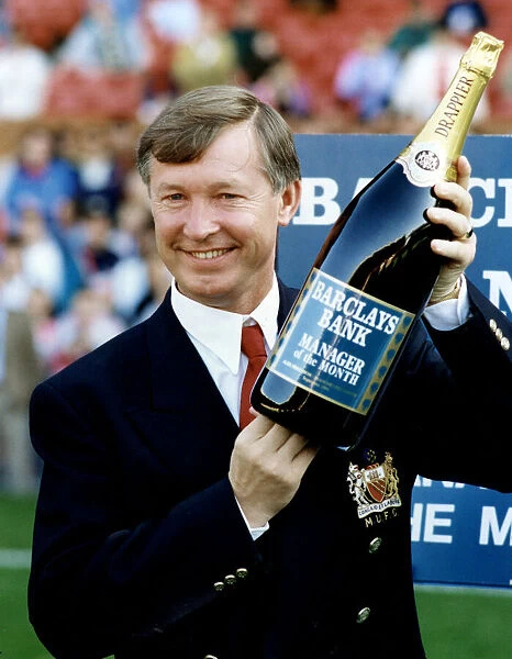 Manchester United manager Alex Ferguson holding a bottle of champagne