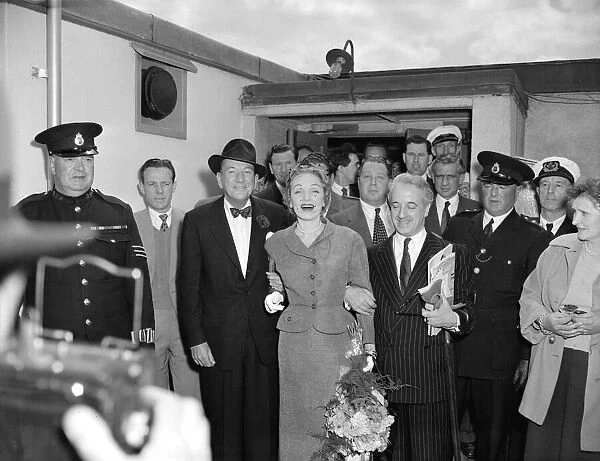 Marlene Dietrich arriving in London for Cabaret actress surrounded by men