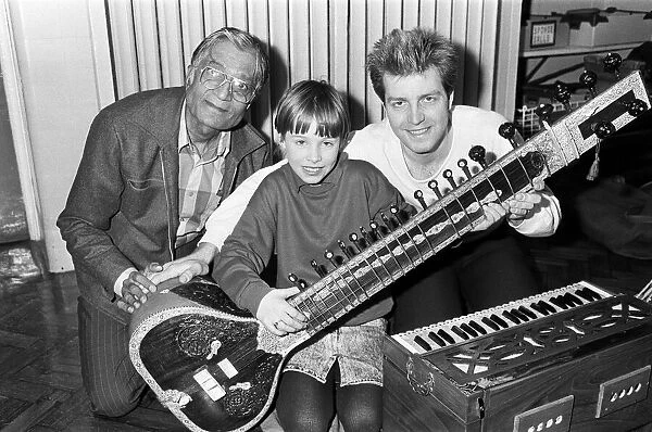Martine Bochat (centre) gets a lesson on the sitar from Virendra Bhatt (left