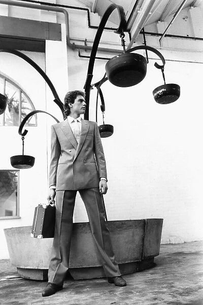 Mens Fashions Spring 1983. Our model wears Double breasted business suit carrying attache