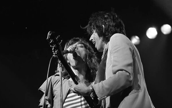 Mick Jagger and guitasrist Bill Wyman performing on stage during a Rolling Stones concert