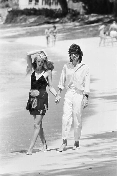 Mick Jagger and Jerry Hall taking a stroll along the beach at Gibbs Bay in Barbados
