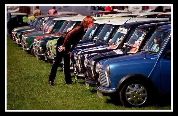 Mini car August 1999 Woman looking at blue Minis Mini cars are at Silverston for 40th