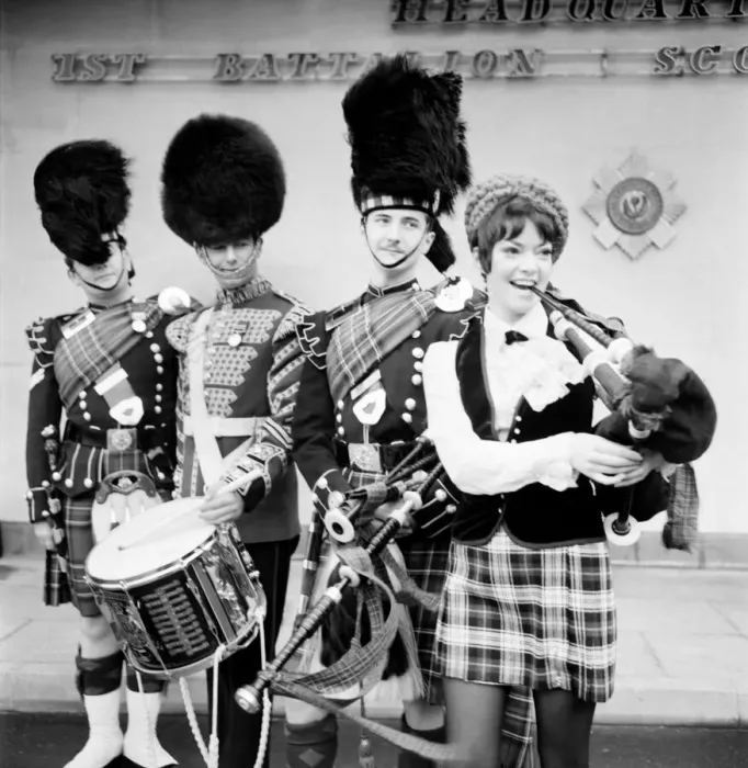 Framed Print : Black and white print of a young woman attempting to play the bagpipes Framed Print : Black and white print of a young woman attempting to play the bagpipes