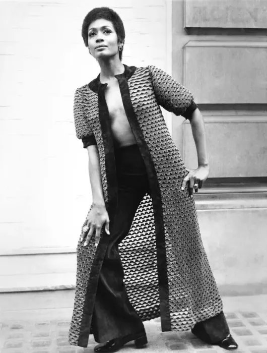 Framed Print : Fashion 1960s Print: A woman models a long coat and matching suede pants Framed Print : Fashion 1960s Print: A woman models a long coat and matching suede pants