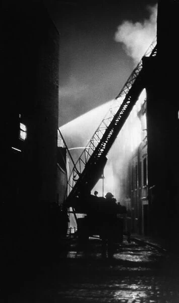 National Fire Service at work on turntable ladders to put out a fire in Brittania Row