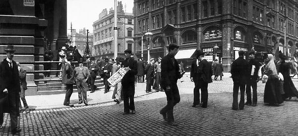 A newspaper seller in Bank Street, Manchester. Circa 1905