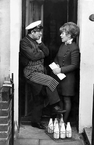 Norman Wisdom: Norman chats to Mrs. Agnes Kirwan on the doorstep. December 1972