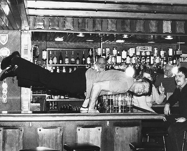 Oliver Reed actor doing press-ups on the bar at the Jamaica Inn Guernsey Currently