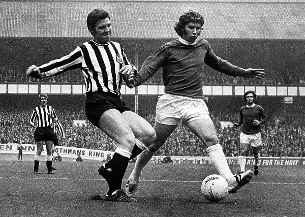 Ollie Burton of Newcastle United tries to tackle Alan Ball of Everton during their match