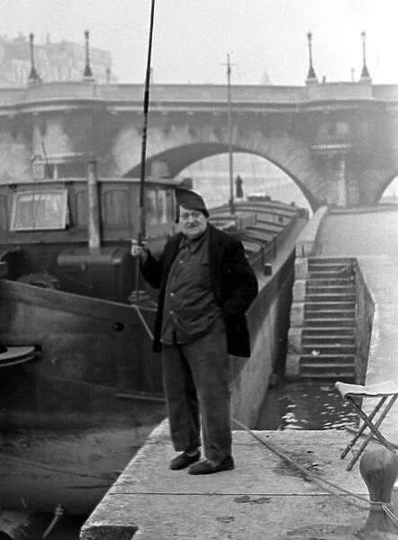 Paris street scenes - Man holding a fishing rod circa 1951