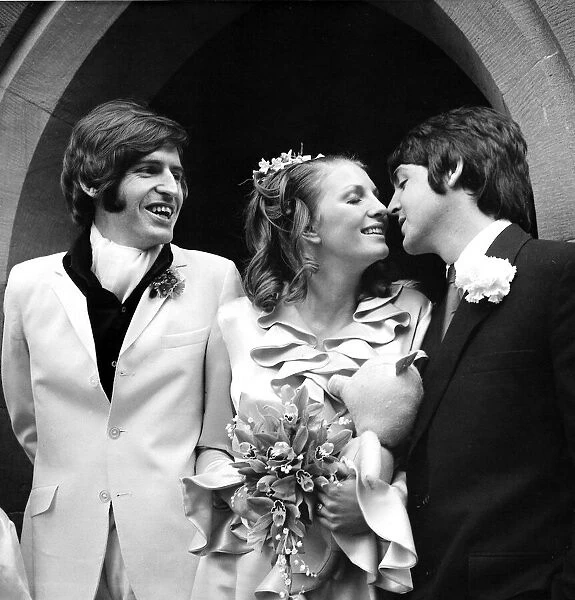 Paul McCartney kisses his new sister in law Angela Fishwick who married his brother Mike