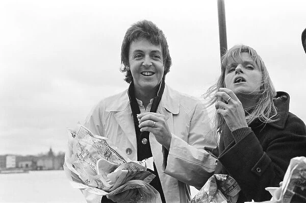 Paul McCartney and his wife Linda of pop group Wings sailing down the River Thames
