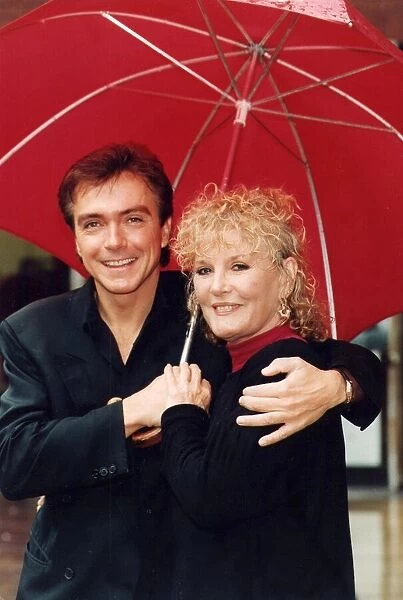 Petula Clark and David Cassidy under umbrella at photocall - July 1993