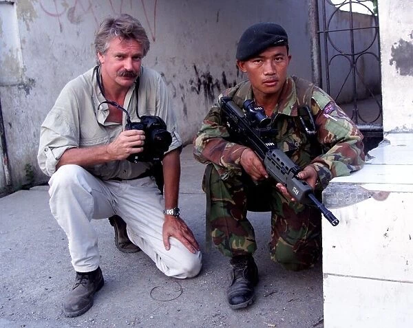 Photographer Mike Moore with Gurkha soldier on patrol in Dilli