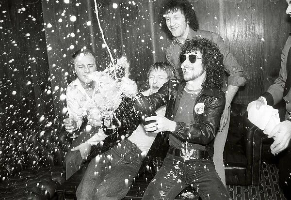 Pop band Black Lace enjoy a bottle of champagne after victory in the Eurovison song