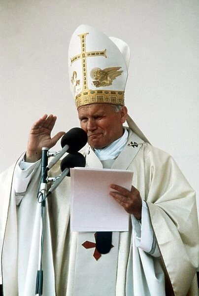 Pope John Paul II delivers his blessing while conducting an open air mass in Bellahouston
