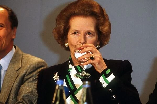 Prime Minister Margaret Thatcher drinking a glass of water at a conference May 1987