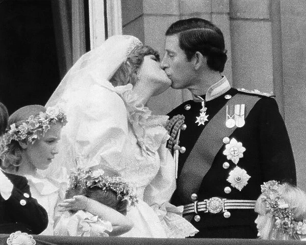 Prince Charles and his new bride Diana kiss on the balcony of Buckingham Palace after