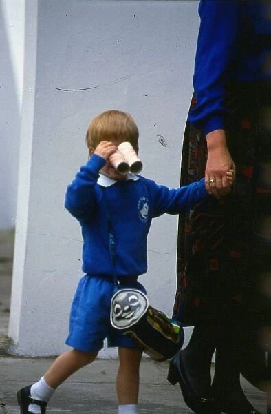Prince Harry September 1987 wearing a blue sweatshirt shorts with binoculars made of