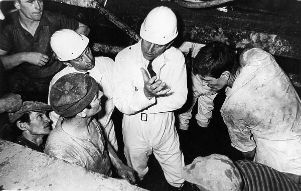 Prince Philip, Duke of Edinburgh, chats to a group of workers on his visit to the tunnel