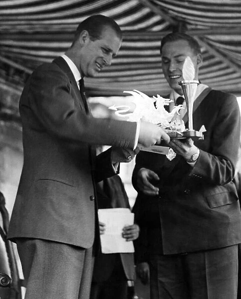 Prince Philip visiting Wales. A scroll and electric lamp stand is presented to the Duke