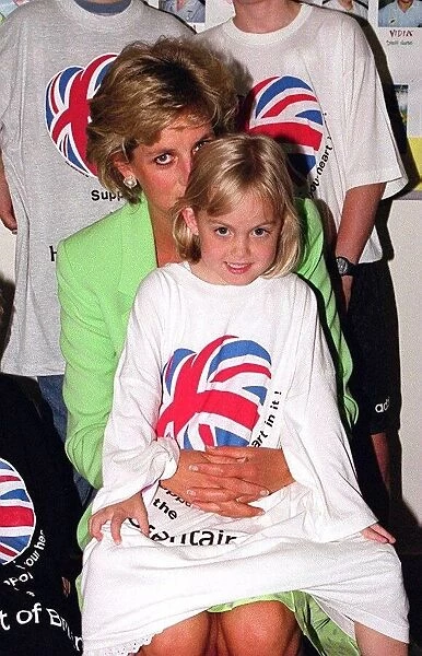 Princess Diana sitting with Jessica Waugh on her lap during a visit to a children